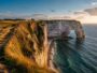 White cliffs and natural arch on the Normandy coast at sunset